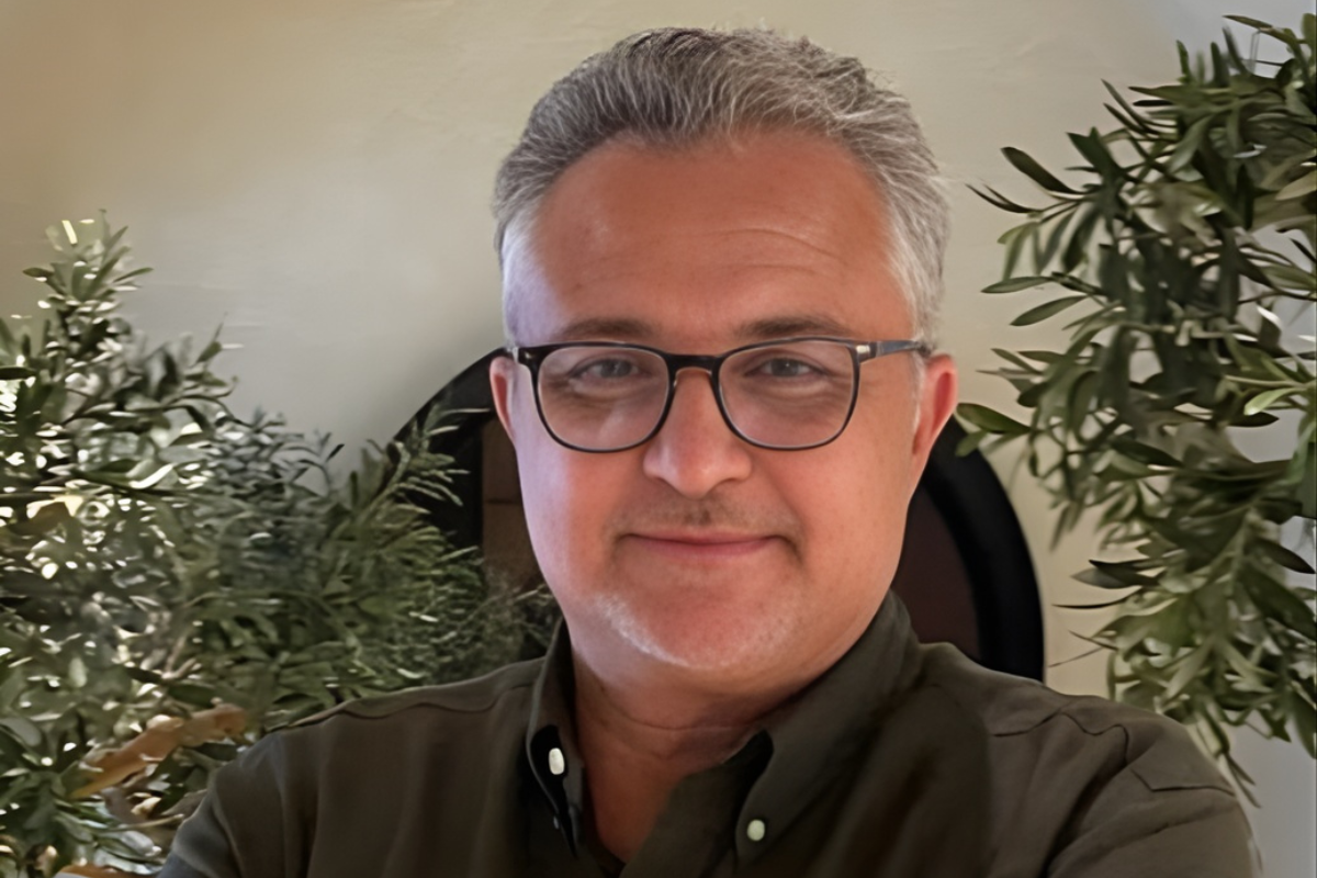 Dr Samir Benmakhlouf founder of London Academy smiling in front of greenery