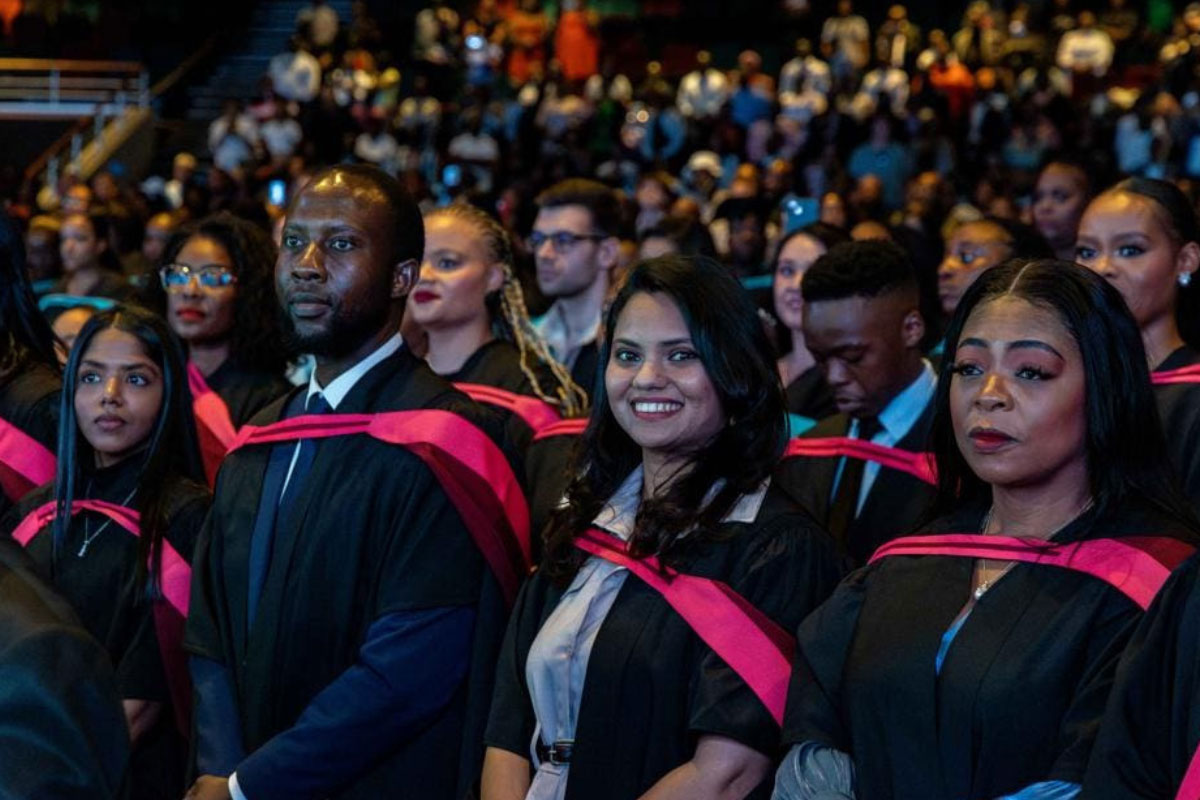 Honoris learners in gowns at a graduation event