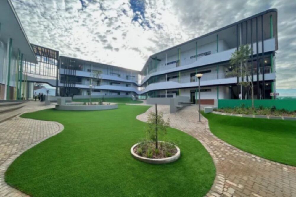Modern campus courtyard with open walkways and landscaped green space