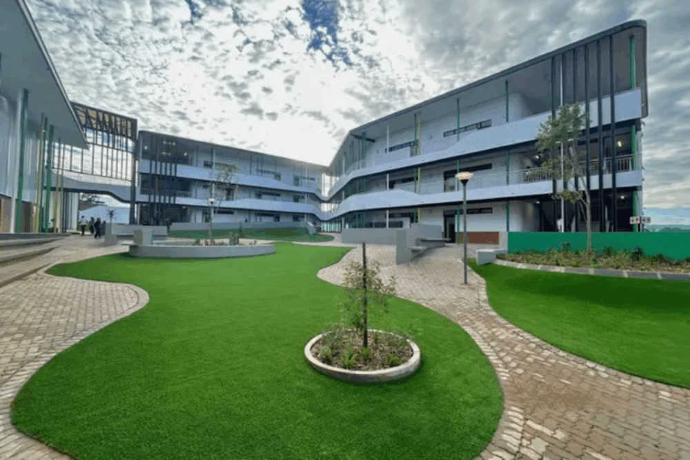 Modern campus courtyard with open walkways and landscaped green space