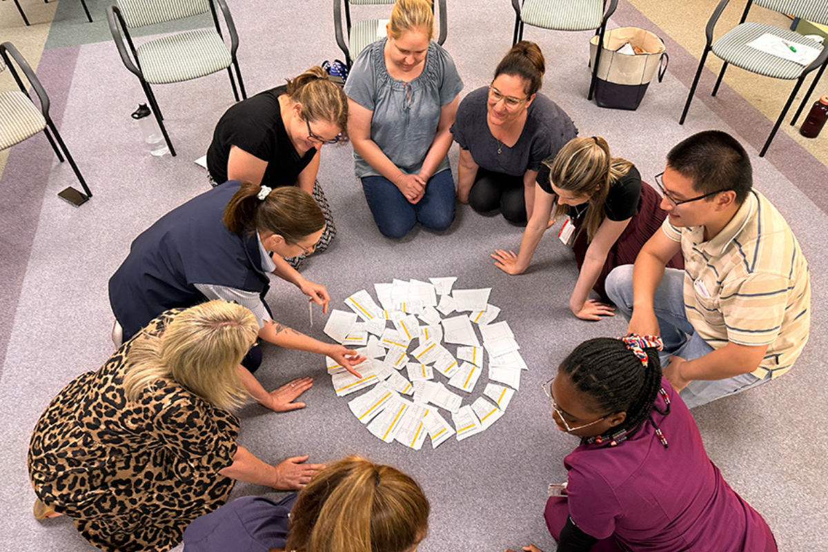 Participants sitting in a circle working together during a cultural immersion workshop