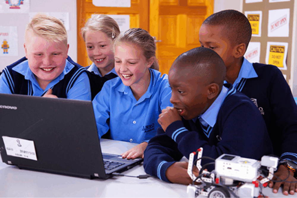Learners in a South African private school classroom working together on a project