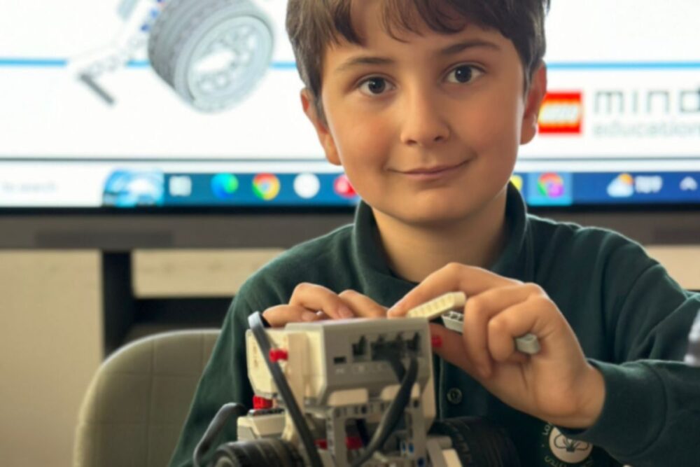Young pupil building a robot model during a technology lesson