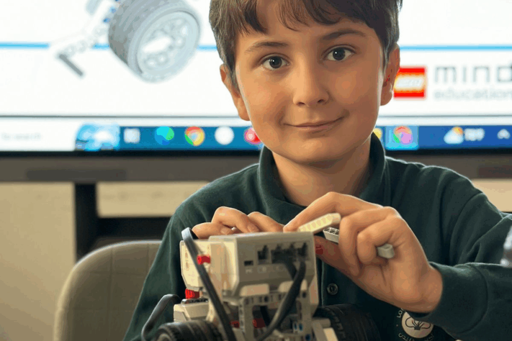 Young pupil building a robot model during a technology lesson