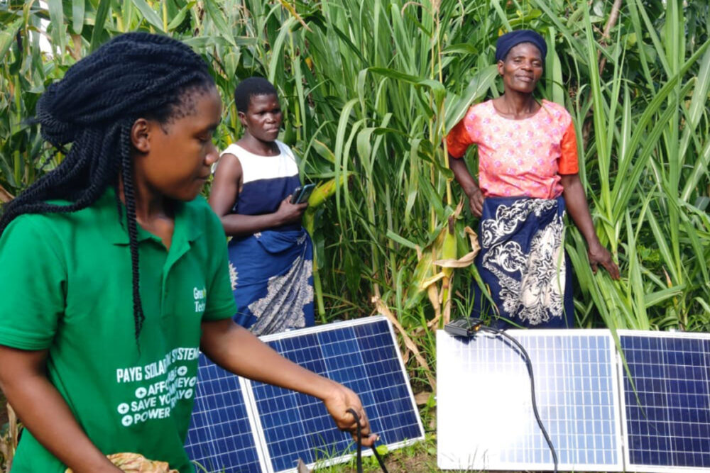 Teenage girl from Malawi demonstrating her solar-powered invention for clean water access