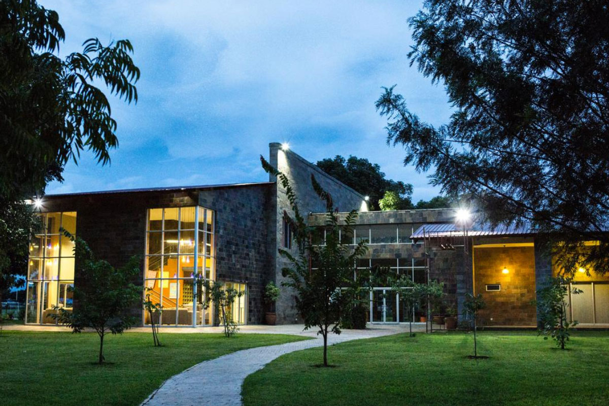 baobab college campus building in lusaka photographed at dusk with lights glowing