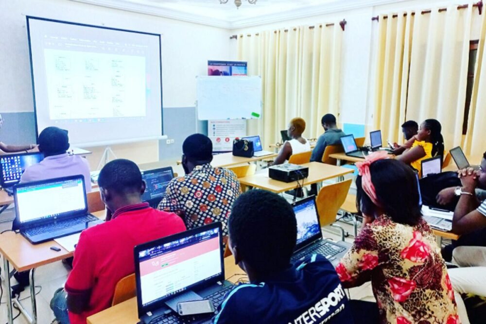 Students in Cameroon learning practical technical skills in a Catholic school classroom