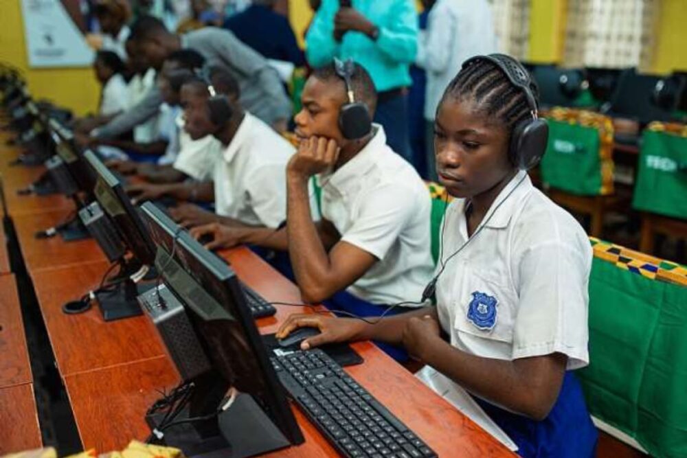 Liberian students engaging in digital learning in a newly built classroom.