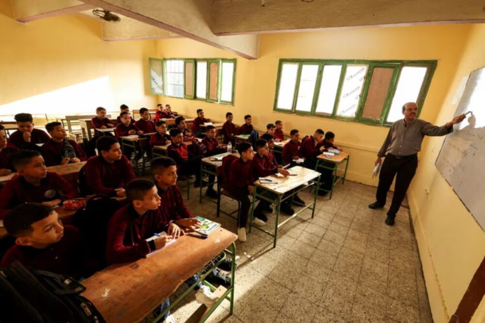 Teacher guiding students during lesson in Egyptian secondary school
