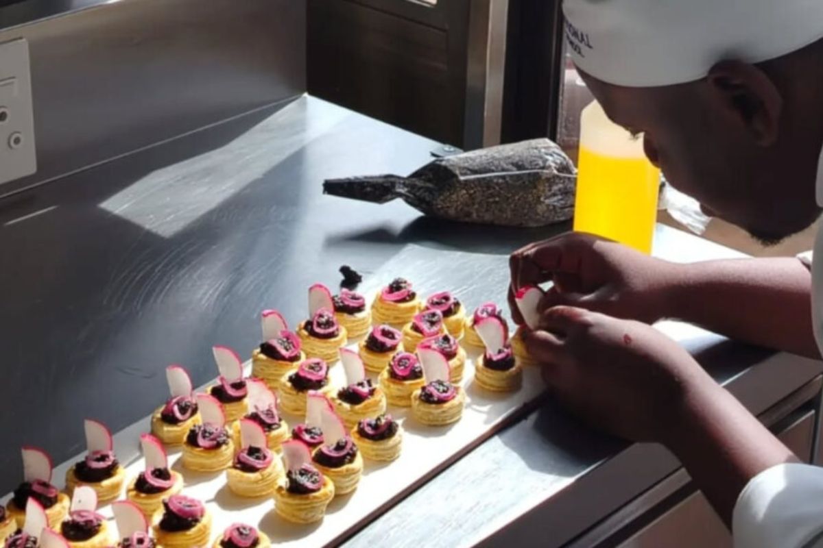 Culinary arts students preparing dishes during a hospitality education workshop