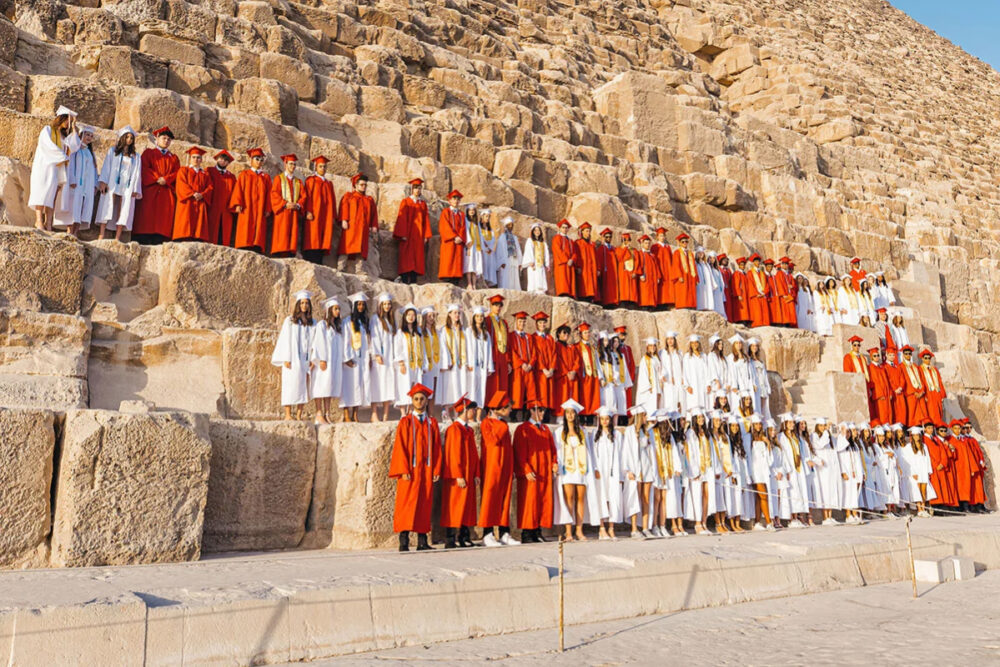 Students celebrate their graduation in a historic Egyptian heritage setting, marking an important milestone surrounded by family, friends and the school community