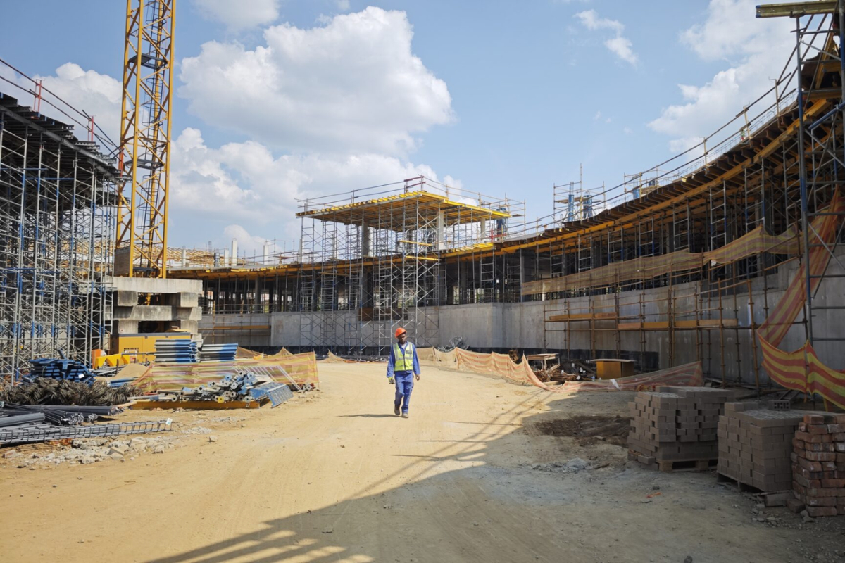 A worker walking along the core node’s main pathway with the cafeteria on the right