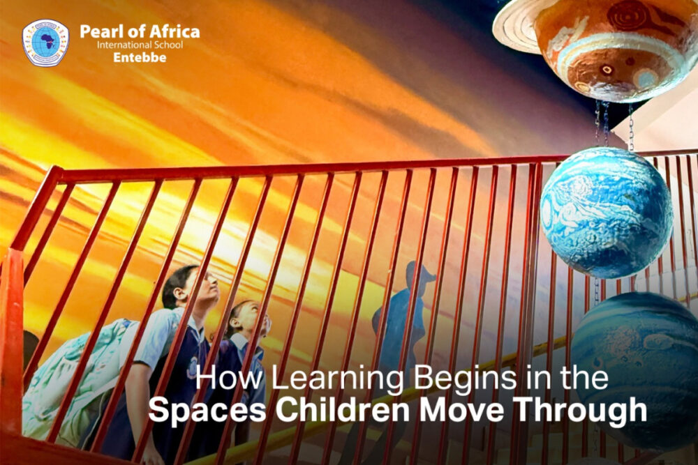 A space-themed ceiling mural and suspended solar system at Pearl of Africa International School encourage students to explore and ask questions beyond the classroom